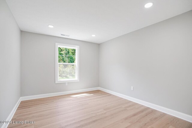 unfurnished room with light hardwood / wood-style floors