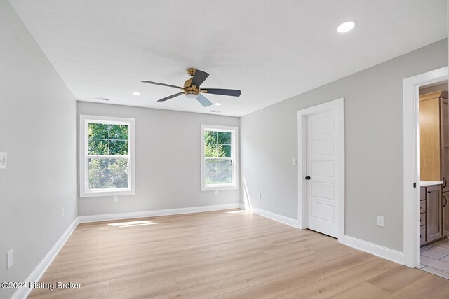 spare room featuring ceiling fan and light hardwood / wood-style floors