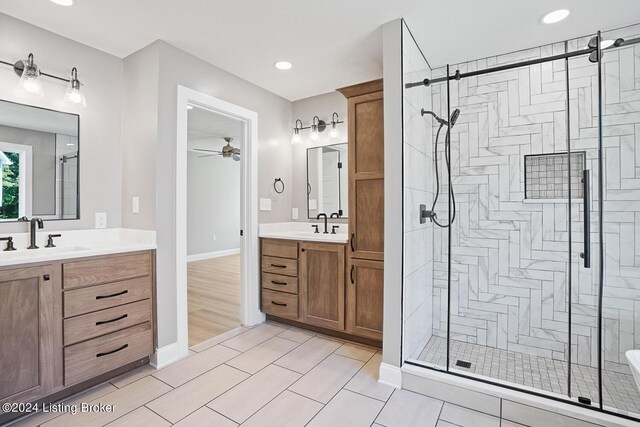 bathroom featuring vanity, hardwood / wood-style flooring, walk in shower, and ceiling fan