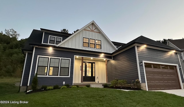 view of front of house featuring a yard and a garage