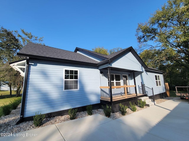 view of side of property featuring a porch