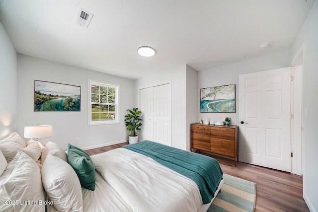 bedroom featuring hardwood / wood-style flooring and a closet