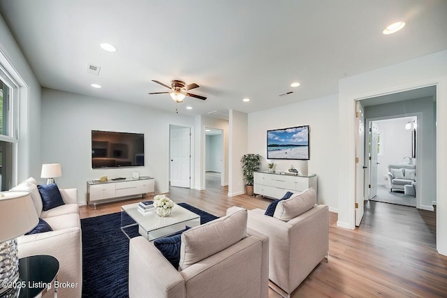 living room featuring ceiling fan and light wood-type flooring