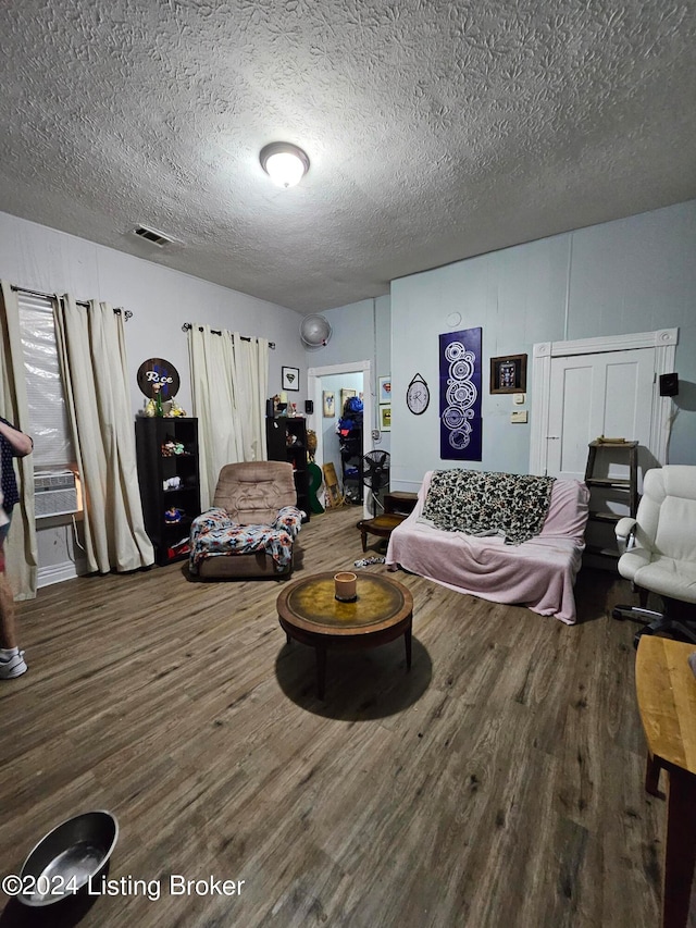 bedroom with hardwood / wood-style floors and a textured ceiling