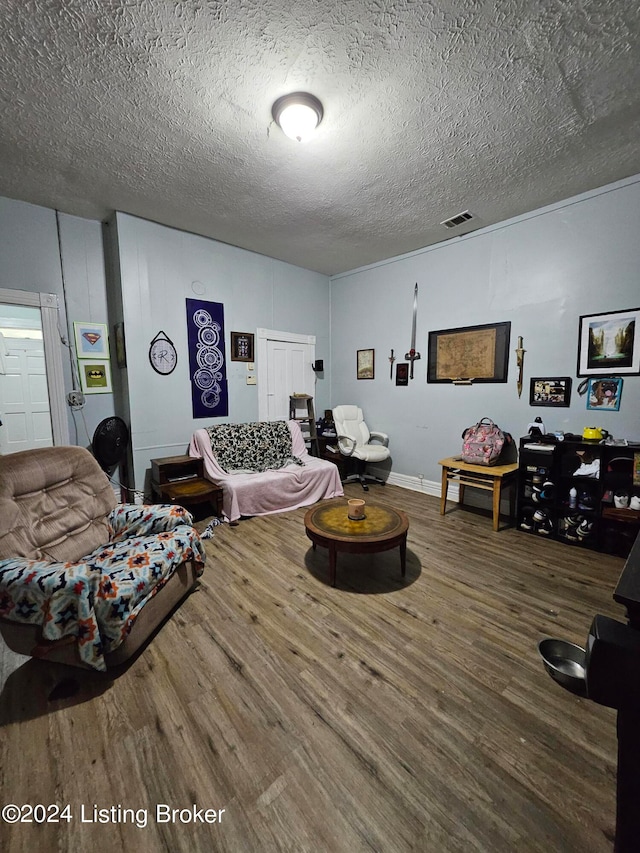 living room featuring hardwood / wood-style flooring and a textured ceiling