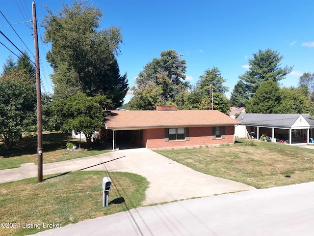 ranch-style home featuring a carport and a front yard