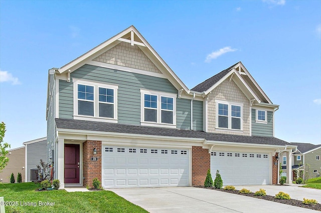 view of front of home featuring driveway, an attached garage, and brick siding