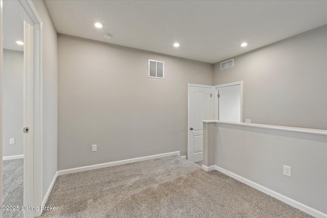 carpeted empty room featuring recessed lighting, baseboards, and a smoke detector