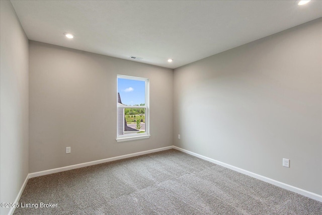 spare room featuring recessed lighting, baseboards, and carpet