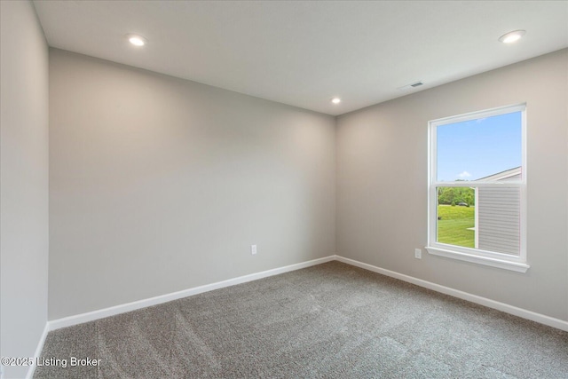 carpeted empty room with baseboards and recessed lighting