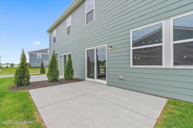 back of house featuring a patio and a lawn