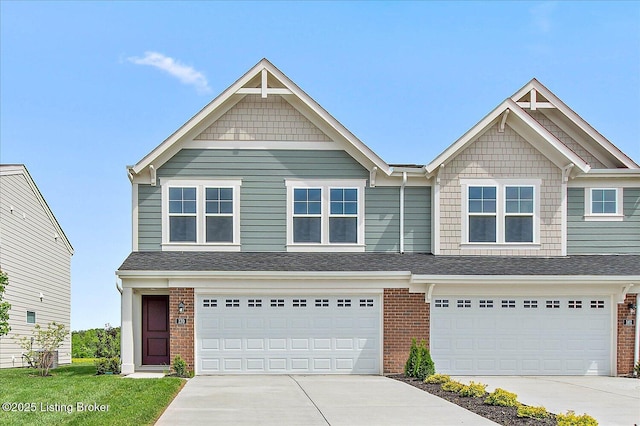 view of front facade featuring concrete driveway, brick siding, and a garage