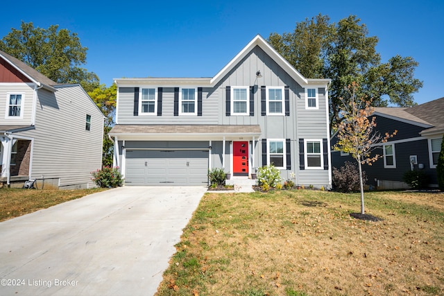 view of front of property featuring a front lawn and a garage