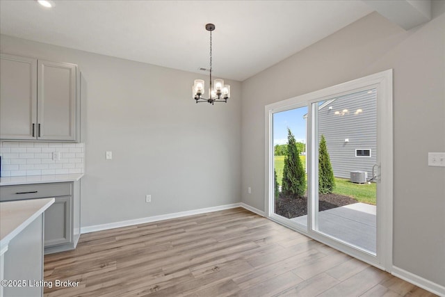 162 Harvest Point Way, Mt Washington, KY 40047 - unfurnished dining area with a chandelier, light wood-style floors, and baseboards