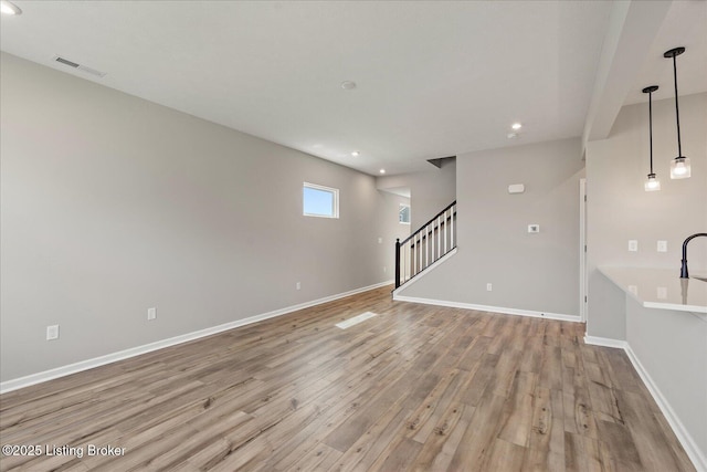 162 Harvest Point Way, Mt Washington, KY 40047 - unfurnished living room with light wood-style floors, recessed lighting, stairs, and baseboards