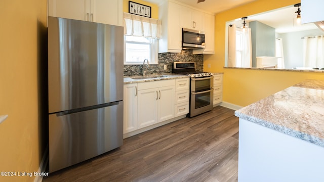 kitchen featuring dark wood-type flooring, white cabinets, appliances with stainless steel finishes, and sink