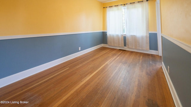 spare room with wood-type flooring