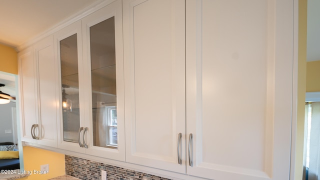 interior details with backsplash and white cabinetry