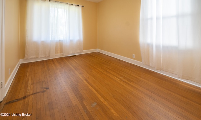 empty room featuring hardwood / wood-style flooring