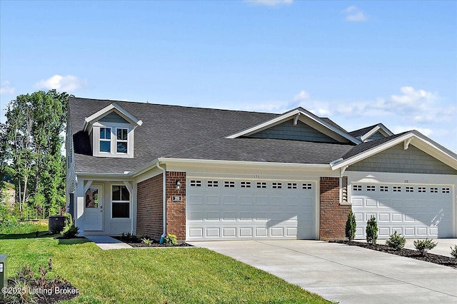 196 Harvest Moon Ct Unit 219A, Shepherdsville, KY 40165 - view of front of house with a garage, driveway, a front lawn, a shingled roof, and brick siding