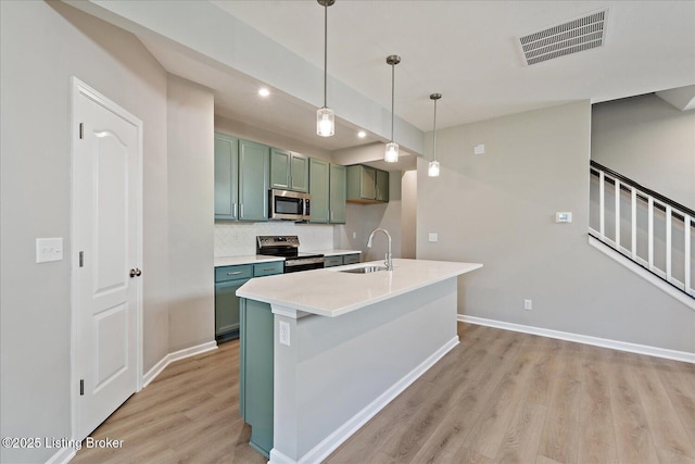 196 Harvest Moon Ct Unit 219A, Shepherdsville, KY 40165 - kitchen featuring stainless steel appliances, green cabinetry, light wood-type flooring, a sink, and baseboards