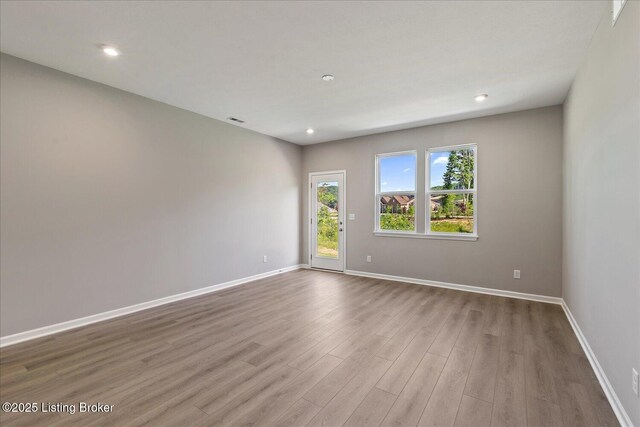 196 Harvest Moon Ct Unit 219A, Shepherdsville, KY 40165 - spare room featuring wood finished floors, baseboards, and recessed lighting