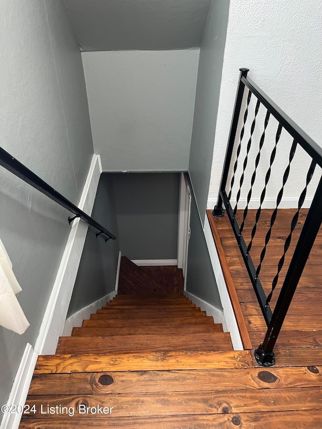 stairway featuring hardwood / wood-style flooring