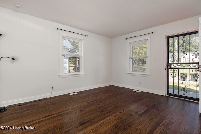 spare room with dark wood-type flooring