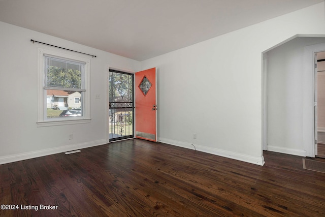 unfurnished room with dark wood-type flooring