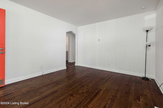 empty room with dark hardwood / wood-style floors