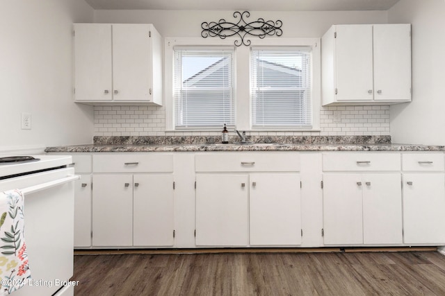 kitchen featuring tasteful backsplash, dark hardwood / wood-style flooring, white cabinetry, and sink