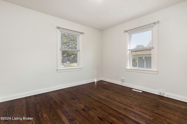 spare room with a wealth of natural light and hardwood / wood-style flooring