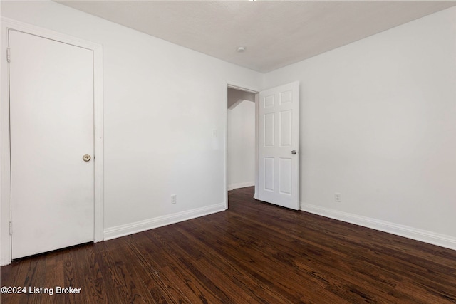 unfurnished room featuring dark hardwood / wood-style floors