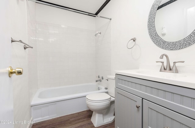 full bathroom with vanity, toilet, hardwood / wood-style floors, and tiled shower / bath