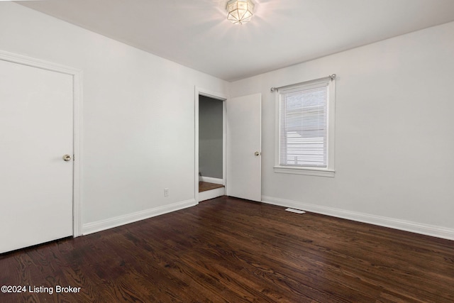 unfurnished room featuring dark hardwood / wood-style flooring