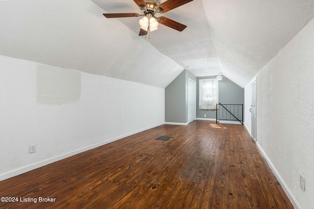 bonus room featuring lofted ceiling, ceiling fan, dark hardwood / wood-style floors, and a textured ceiling