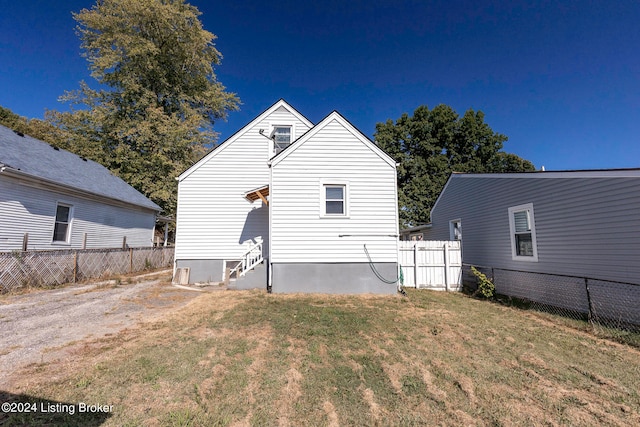 back of house with a lawn