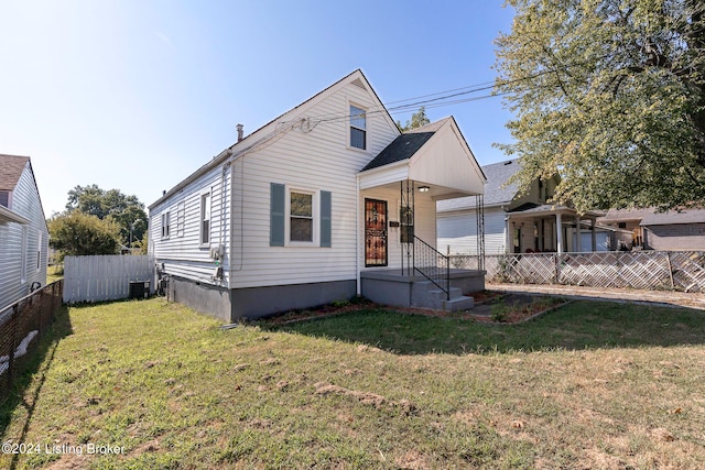 view of front of house featuring a front yard and central AC unit