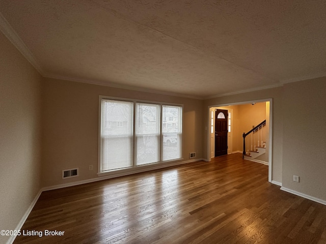 unfurnished living room featuring dark wood-style floors, baseboards, stairs, and visible vents