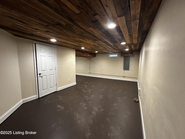 finished basement with wooden ceiling, electric panel, baseboards, and recessed lighting