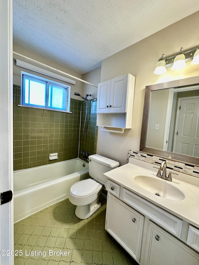 full bathroom featuring toilet, washtub / shower combination, a textured ceiling, and vanity