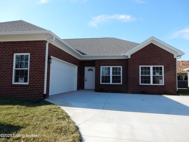 ranch-style house featuring brick siding, an attached garage, a shingled roof, and concrete driveway