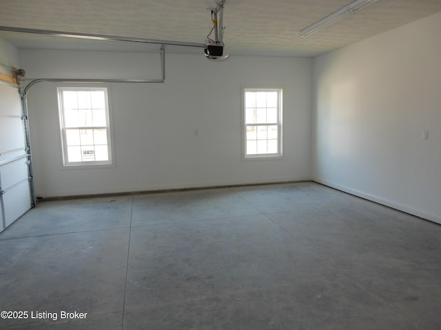 garage with baseboards and a garage door opener