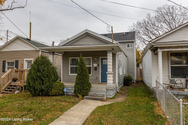 bungalow-style home featuring a front yard