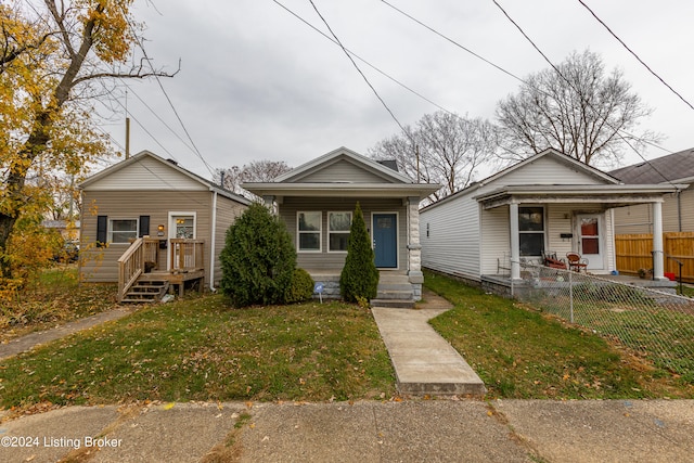 bungalow-style home featuring a front yard