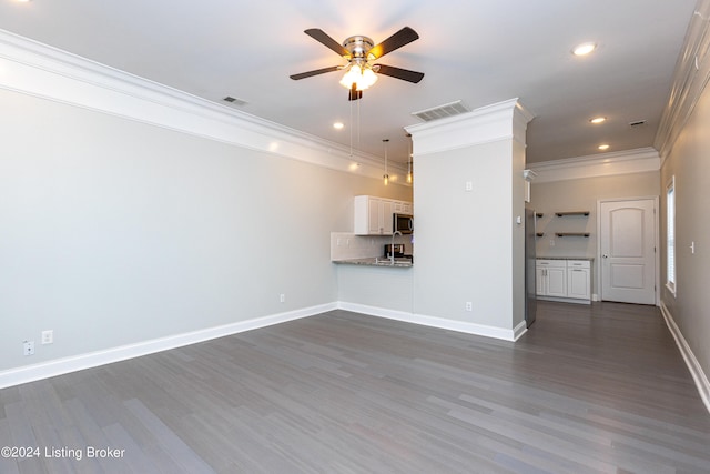 unfurnished living room featuring ceiling fan, ornamental molding, and dark hardwood / wood-style flooring