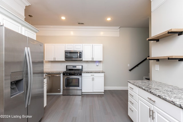 kitchen featuring stainless steel appliances, dark hardwood / wood-style flooring, and white cabinets