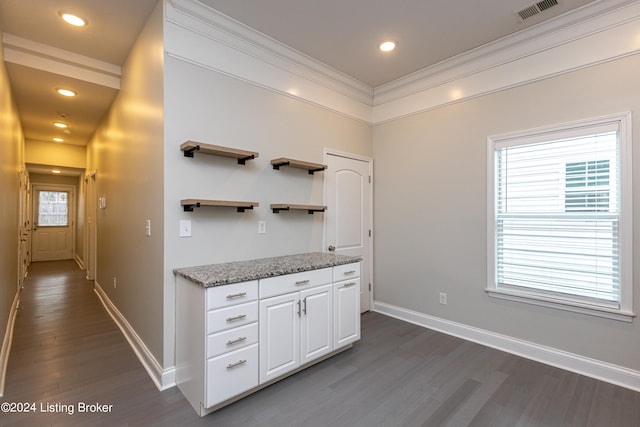 kitchen featuring ornamental molding, white cabinetry, light stone countertops, and dark hardwood / wood-style floors