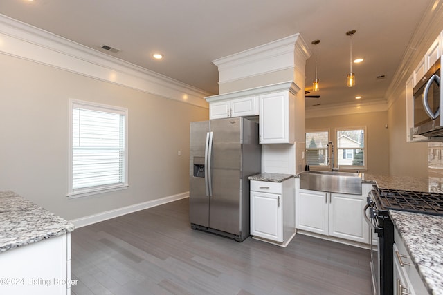 kitchen featuring appliances with stainless steel finishes, white cabinetry, sink, and dark hardwood / wood-style floors