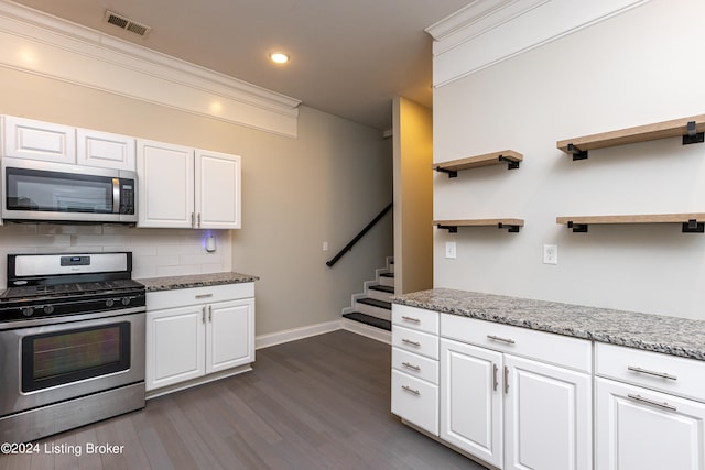 kitchen featuring white cabinetry, dark hardwood / wood-style flooring, backsplash, and stainless steel appliances